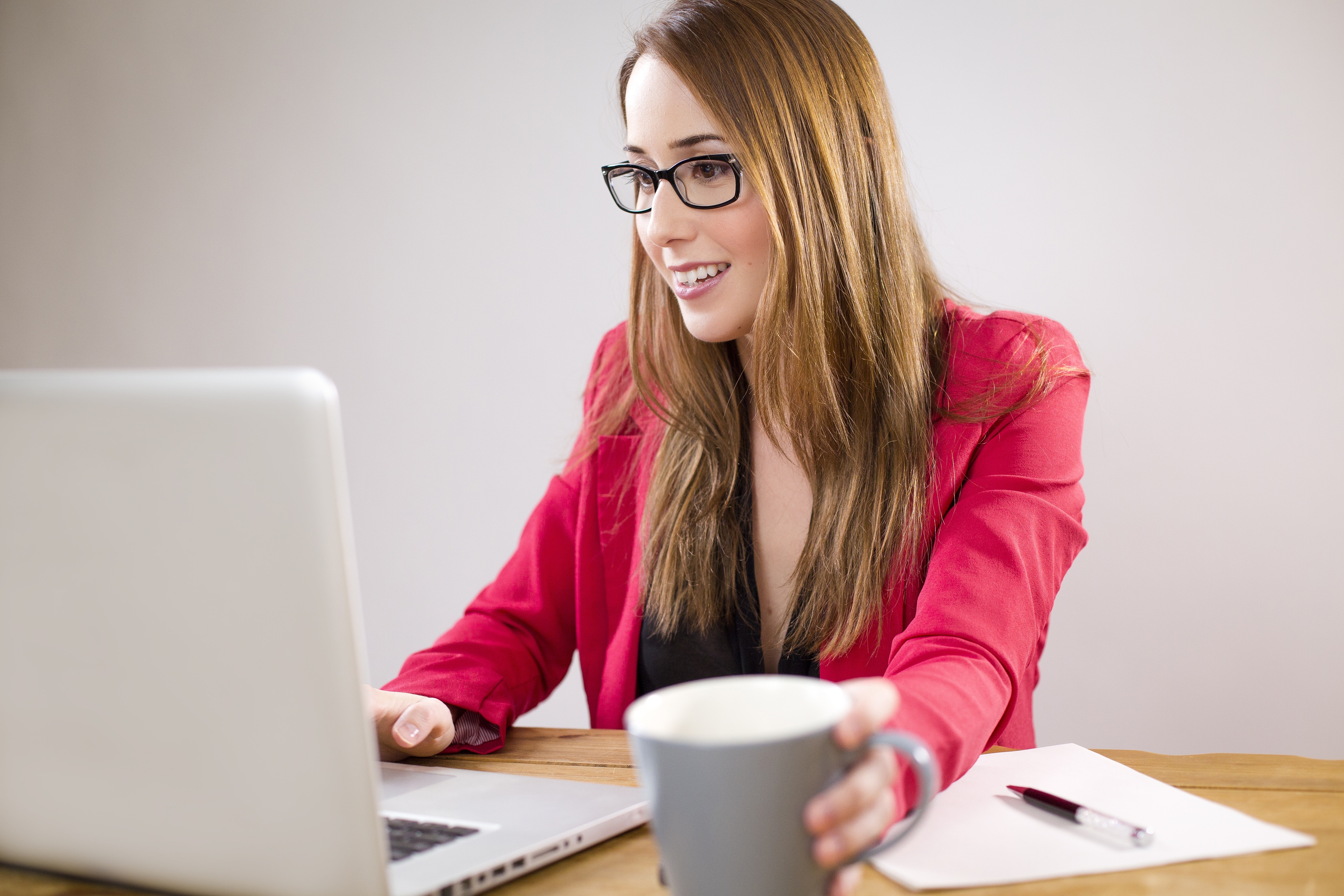 woman, desk, sitting, drinking coffee, computer
